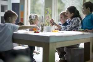 Teacher and children drawing at tutoring academy