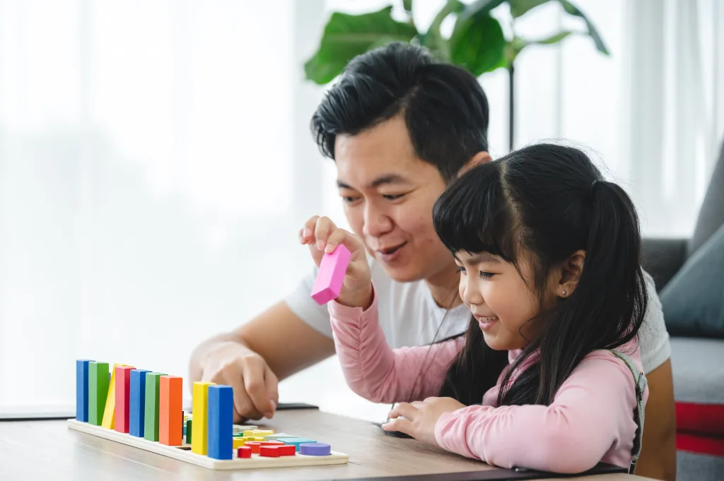 little girl learning math with young father through activities